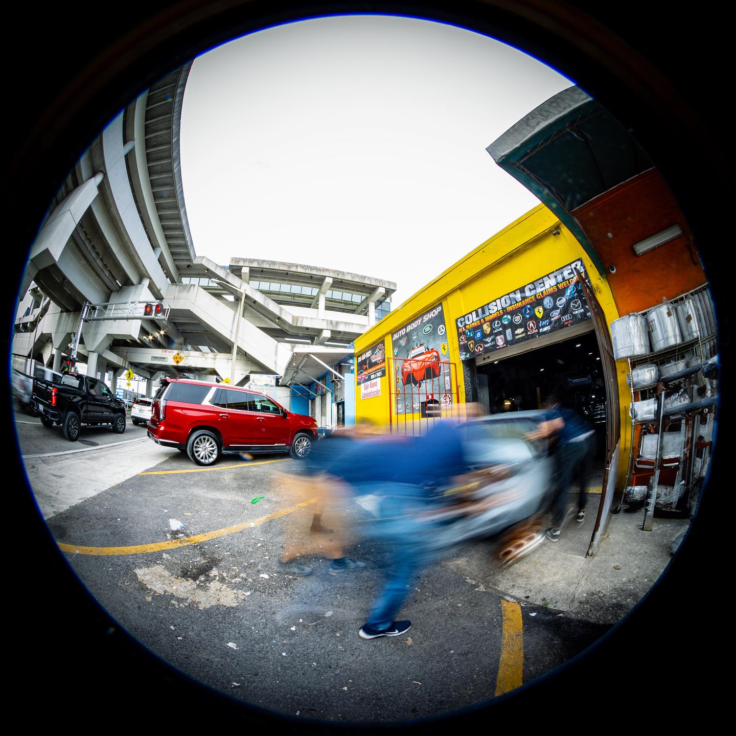 Fisheye action shot of the team pushing a car into the bay